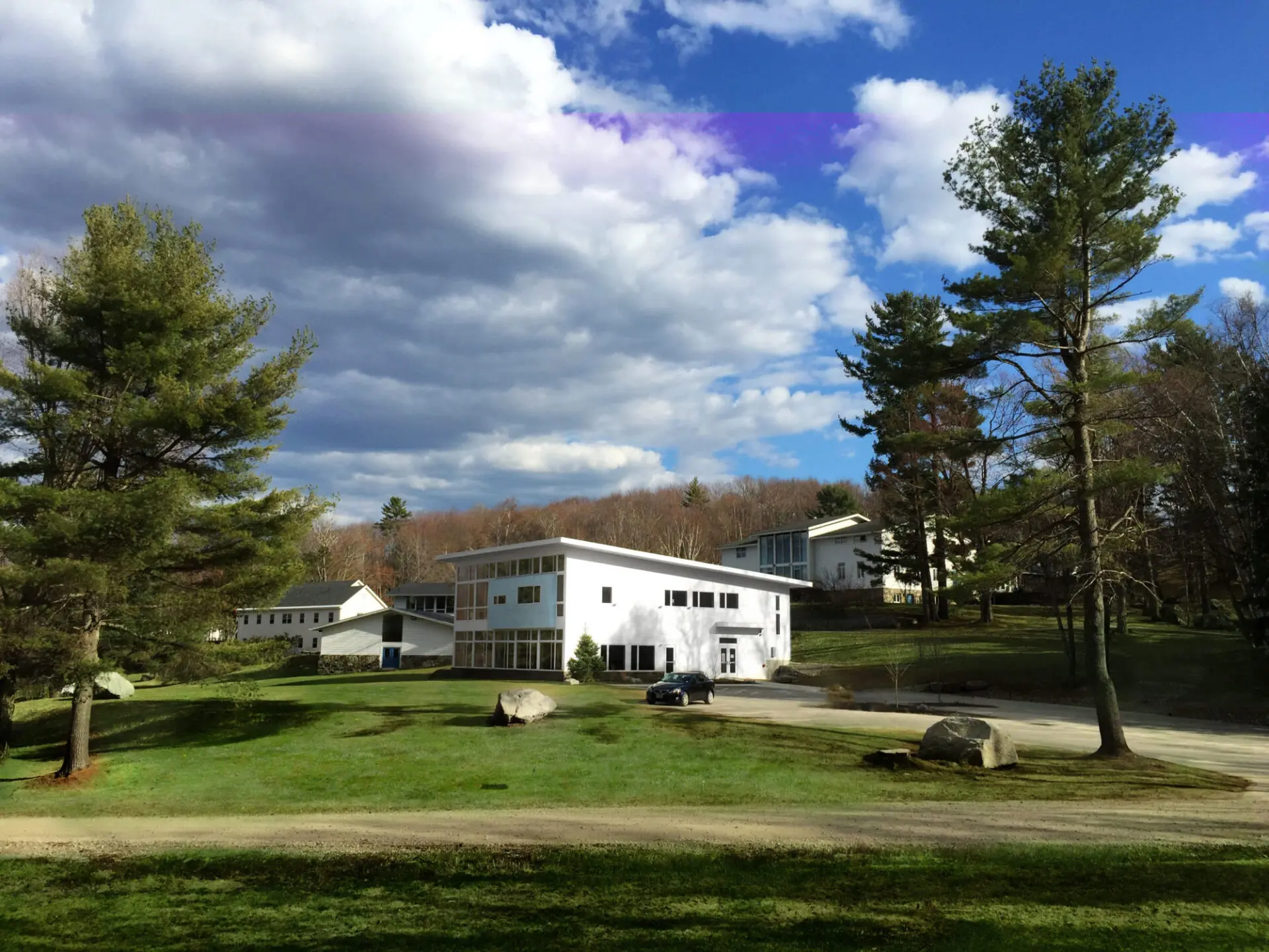 exterior of modern school with trees and sky