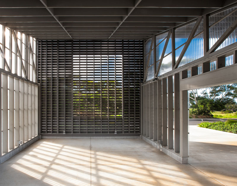 The interior of the open-air education pavilion at the Hawaii Wildlife Center. The side walls are translucent corrugated polycarbonate to keep rain out and the end wall is composed of varying widths of fiber-cement slats, spaced apart at different intervals to allow for controlled natural ventilation from the steady trade winds. Photo Credit: Ethan Tweedie Photography