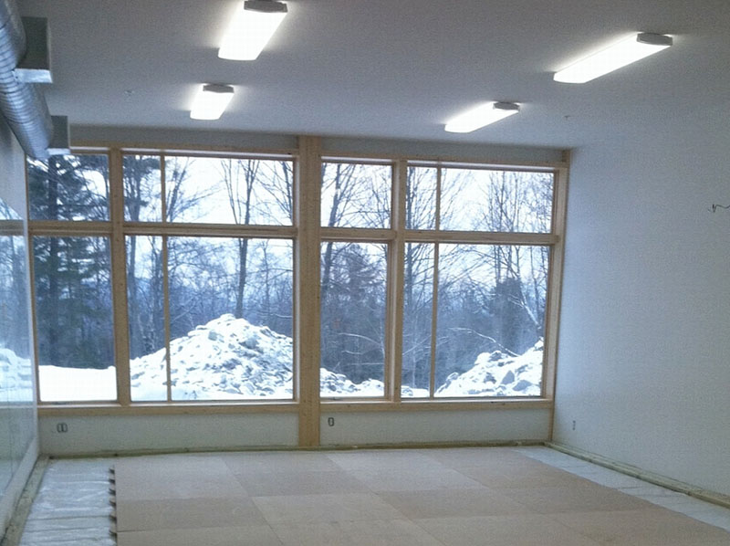 A wall of mirrors reflects and expands the distant mountain views in the smaller of the two dance studios. All lighting in the building is LED.