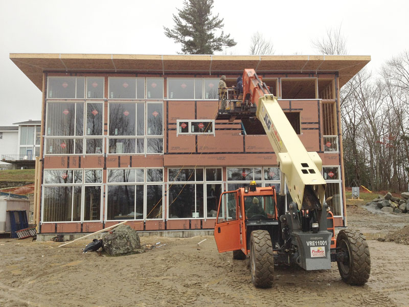 Since our last blog post, one substantial change has been the new curtain wall facing up and out to the White Mountains. Here Bensonwood is installing the Marvin windows onto the custom fabricated laminated Nordic black spruce curtain wall structure from a company in Canada called Nordic.