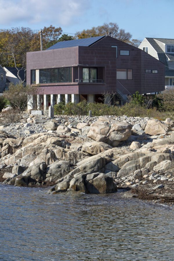 Sleek exterior of a seaside home with a focus on universal accessibility and environmental integration