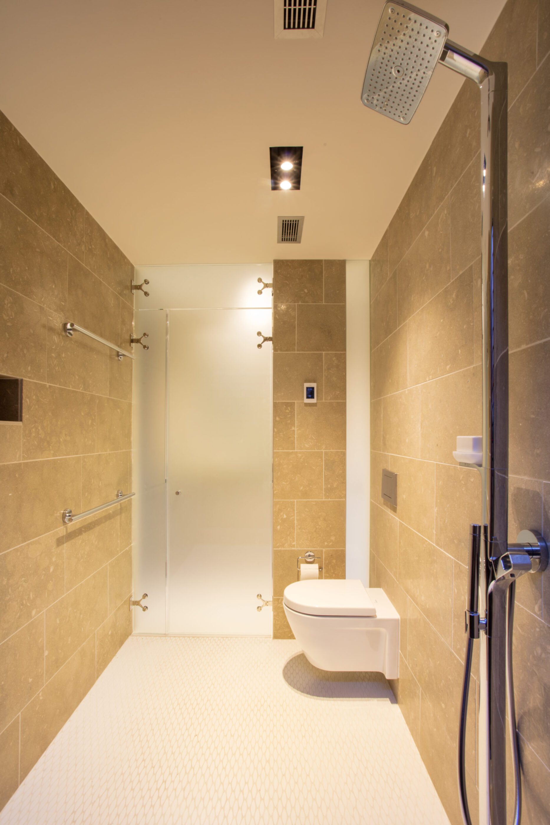 Seaside getaway bathroom with wide doors, a roll-in shower, and modern finishes